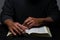 African American Person Studying the Bible Sitting at Desk