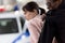 african american policeman arresting woman and talking on portable