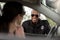 african american policeman in sunglasses smiling to young woman sitting