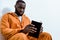 african american prisoner holding book and looking