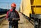 African american railway man with tablet computer at freight train terminal