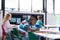 African american schoolboy working at his desk in diverse elementary class, copy space