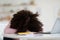 African american schooler lying on table, sleeping