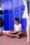 African american schoolgirl sitting next to lockers in corridor at school