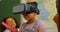 African American schoolgirl using virtual reality headset in classroom at school 4k