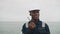 African american seaman speaks with VHF walkie-talkie radio in hands