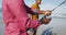 African american senior father and twin teenage sons standing on a beach fishing and talking