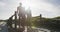 African American senior father and two teenage sons holding fishing rods walking on the beach