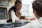 African american senior woman serving take away food inside food truck - Focus on female face