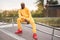 African-american smiling black man yellow hoodie outside Happy emotional afro model guy sitting skate park summer day Free space