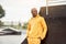 African-american smiling black man yellow hoodie outside Happy emotional afro model guy walking skate park summer day Free space