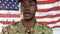 African American soldier hand on heart with US flag waving and constitution foreground