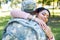 african american soldier in military uniform hugging happy girlfriend