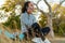 African american sportswoman talking on cellphone while sitting in park