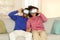 African American spouses wearing virtual reality headsets in living room