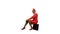African American stewardess in a red suit sits on a suitcase smile . Alpha channel