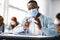 African american student applying antibacterial sanitizer on hands