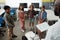 African American teacher with tablet standing in front of schoolkids and robot