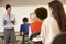 African American teacher teaching at front of class