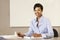 African American teacher working at desk