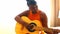 African american teenage girl practicing her skill on acoustic guitar