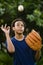 African American teenager tossing a baseball