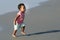 African American toddler running on the beach