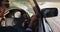 African american woman adjusting side view mirror while driving in convertible car