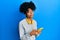 African american woman with afro hair using smartphone typing message depressed and worry for distress, crying angry and afraid