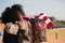 African-American woman with American flag embracing her partner, an American soldier who has just arrived from a mission. Army