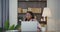 African american woman answer a call on a mobile phone while working on laptop