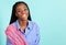 African American woman in blue blouse with a pink accent sash in the studio