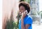 African american woman in a blue shirt speaking at phone