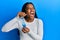 African american woman with braided hair holding slime angry and mad screaming frustrated and furious, shouting with anger looking