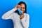 African american woman with braided hair holding slime smiling with a happy and cool smile on face