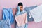 African american woman with braided hair washing clothes at clothesline yawning tired covering half face, eye and mouth with hand