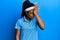 African american woman with braided hair wearing tennis player uniform surprised with hand on head for mistake, remember error