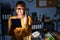 African american woman with braids working at the office at night with tablet gesturing finger crossed smiling with hope and eyes