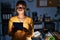 African american woman with braids working at the office at night with tablet puffing cheeks with funny face