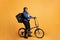 African american woman carrying food delivery thermal backpack standing riding bike in studio