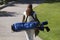 African American Woman Carrying Golf Bag