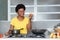 African american woman cooking with tomato