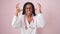 African american woman doctor angry and stressed over isolated pink background