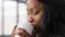 African american woman drinking hot tea or coffee