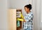 African american woman dusting and cleaning home