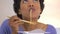 African American woman eating up noodles from chinese take out