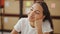 African american woman ecommerce business worker sitting on table thinking at office