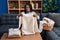 African american woman folding clean laundry smiling looking to the side and staring away thinking