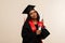 African american woman in graduate dress and mortarboard