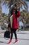 African American woman with handbag posing in the street